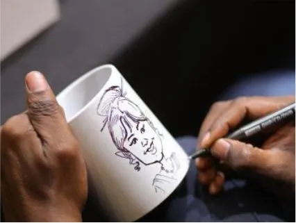 Live caricature artist drawing sketches for employees at a corporate Diwali event